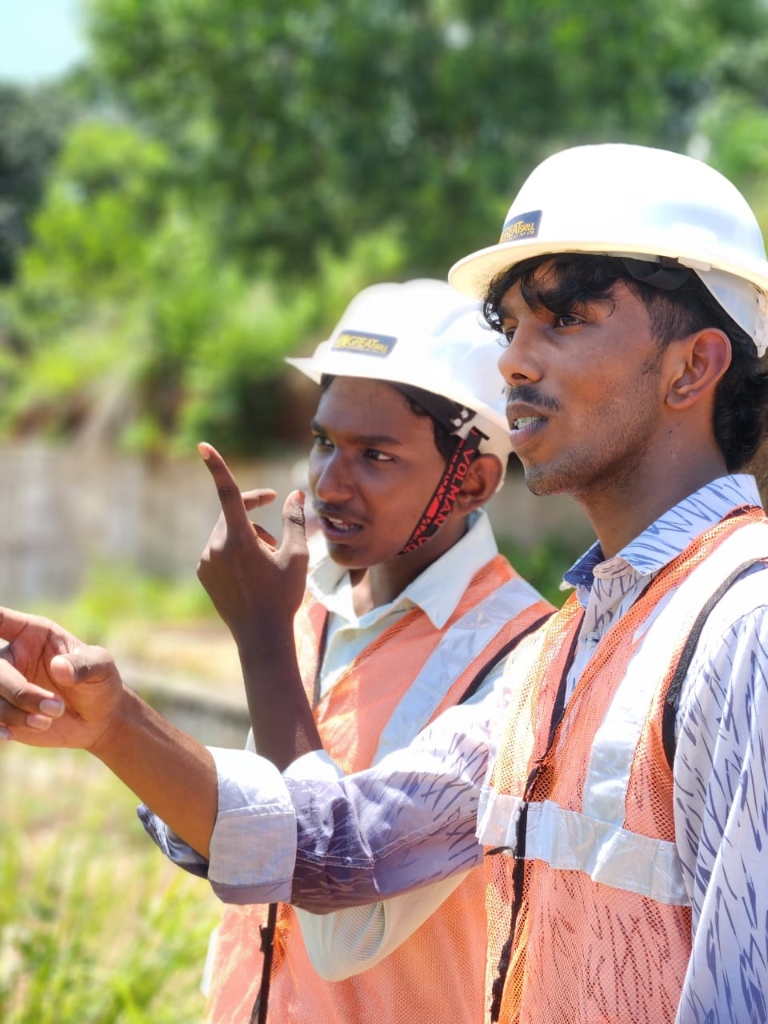 Instructor pointing out key structural details to a student on site