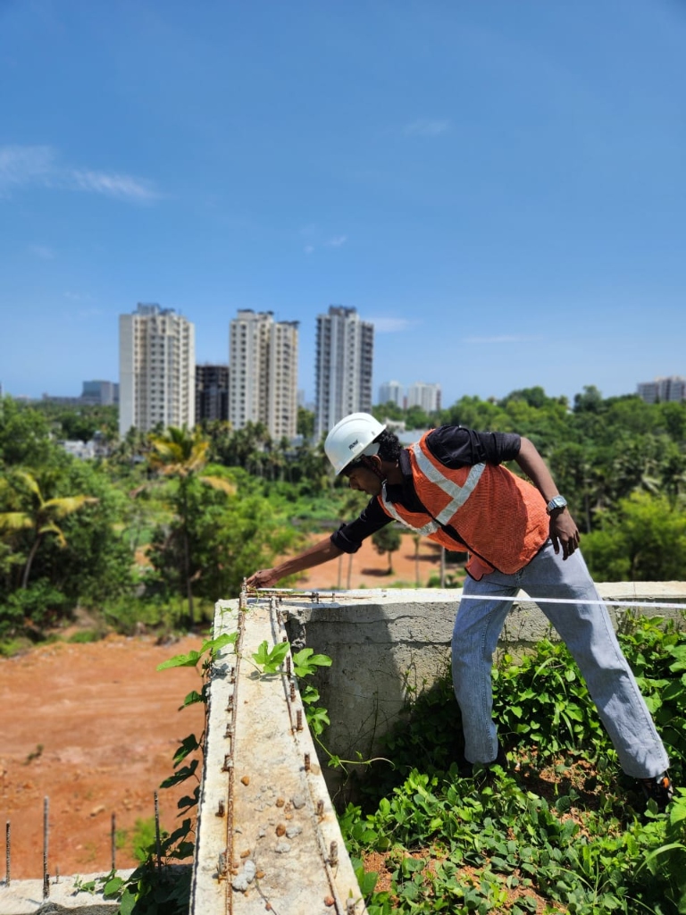 Student performing measurement work on a concrete foundation